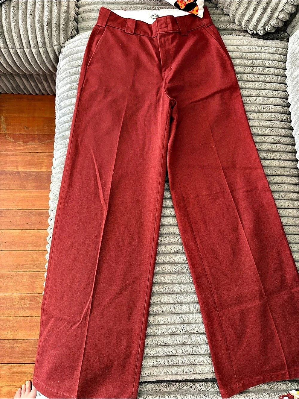 A pair of rust-red wide-leg cotton blend trousers by Dickies.
- Size 27